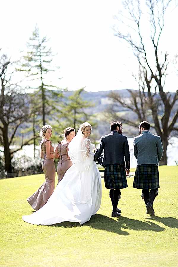 bridal party walking away with loch lomond in the distance