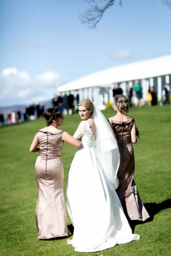 bride walking away with bridesmates