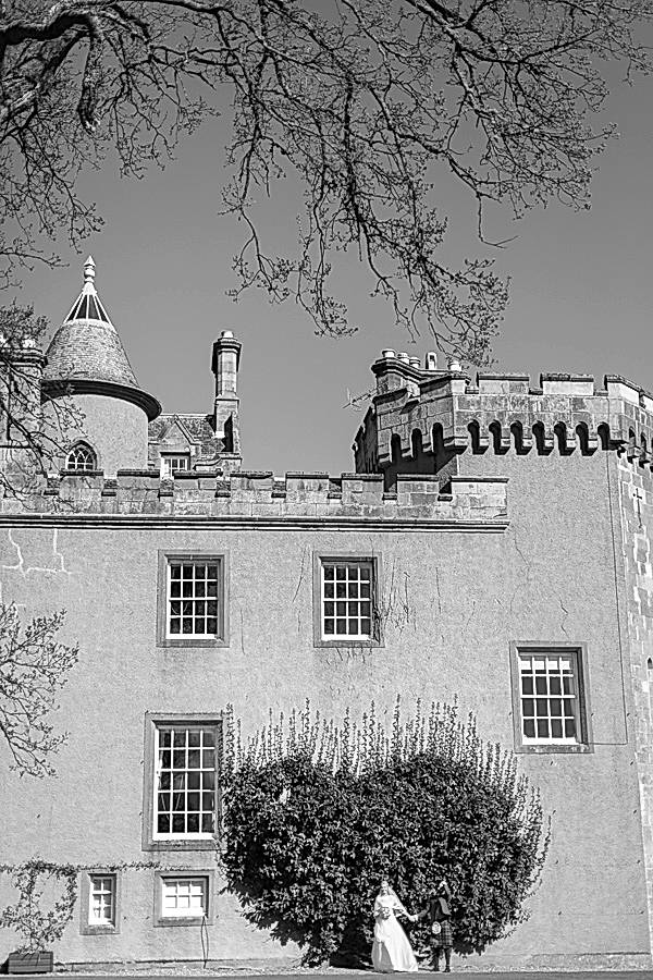 boturich castle wedding bride and groom standing next to castle photos by fotogenic of scotland