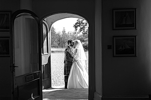 bride and groom kissing at Boturich Castle Wedding