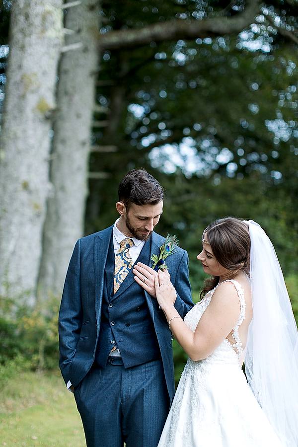 bride and groom looking at their weddings rings