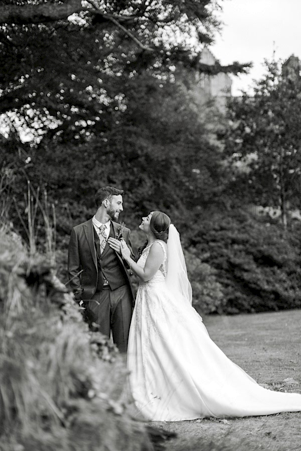 wedding photos of newlyweds looking at each other in ardkinglas garden