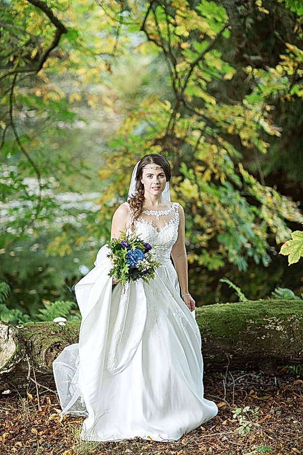 bride standing in a forest scotland