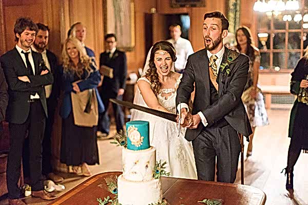 newlyweds cutting cake at scottish castle wedding venue