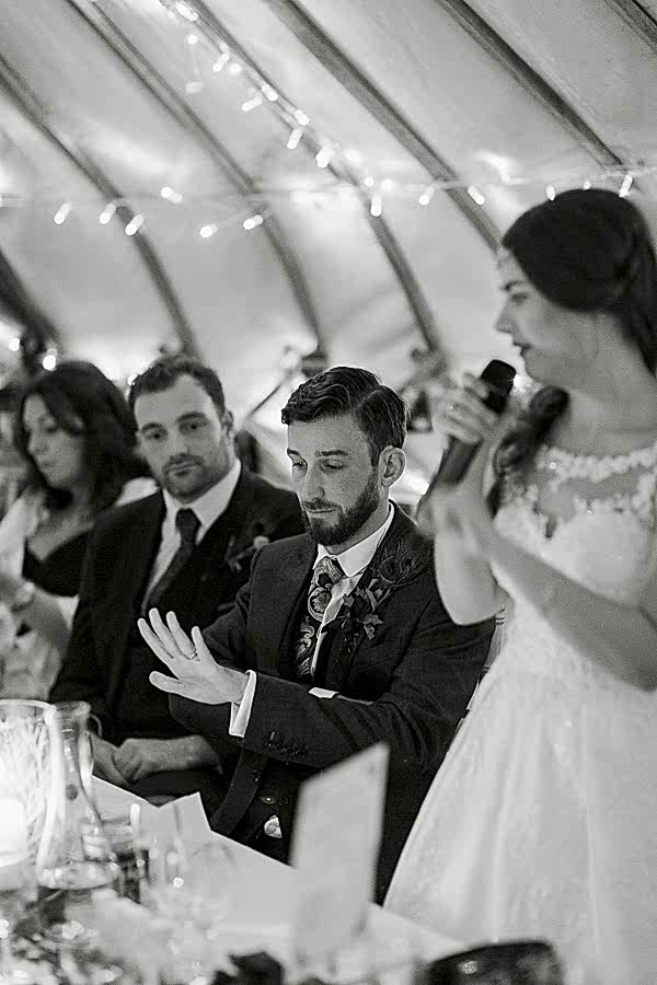 wedding photos glasgow, groom looking at his ring during speeches