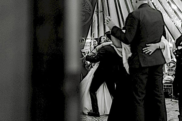 bride and groom embraced during dance