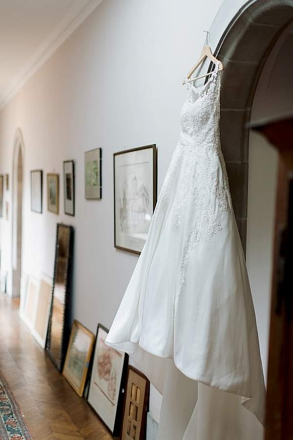 wedding dress hanging in a hall at ardkinglas