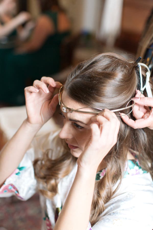 bride putting on a hair piece