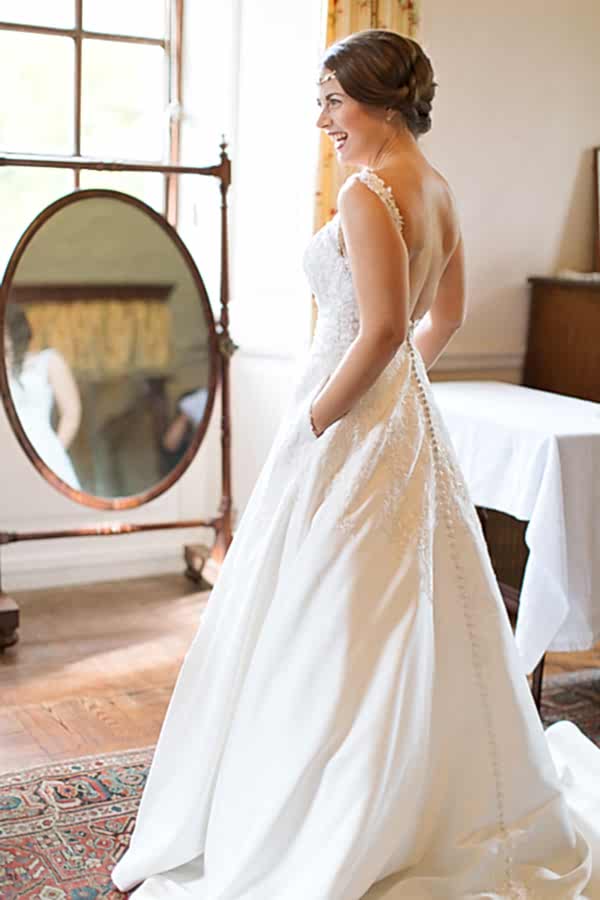 bride laughing with her hands in pockets weddign dress