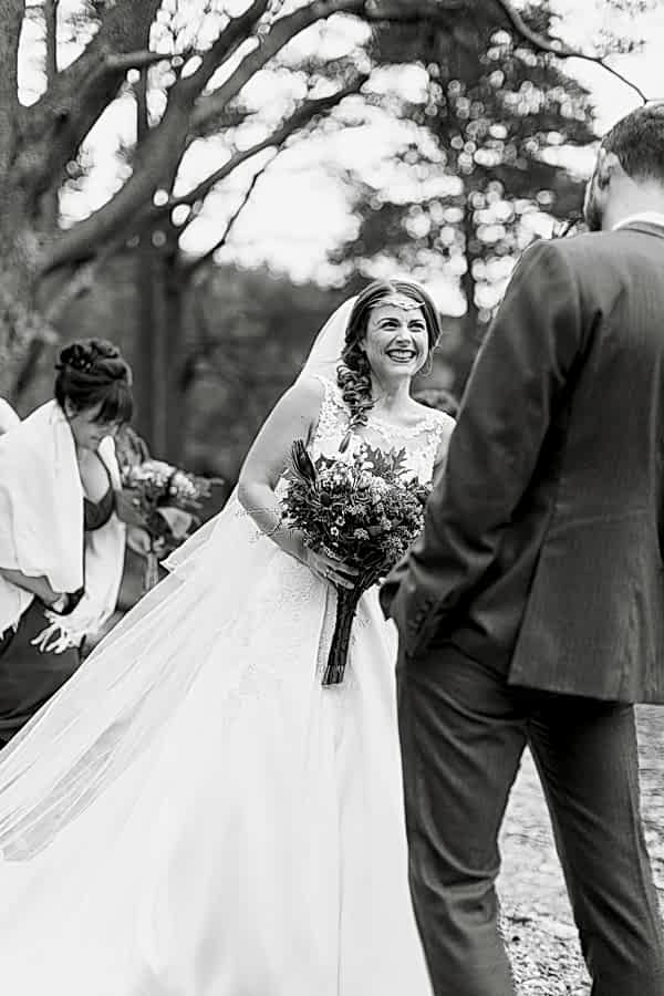 brdie and groom laughing at ceremony outside