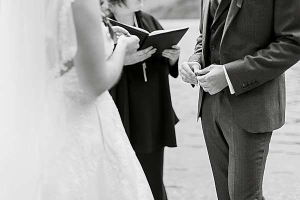 groom holding weddig ring during ceremony