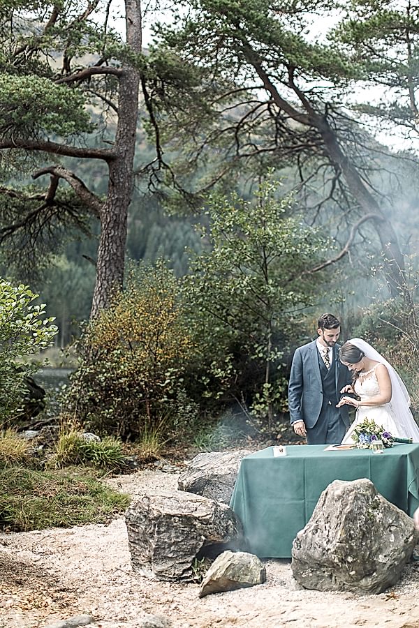 bride and groom looking at their wedding rings