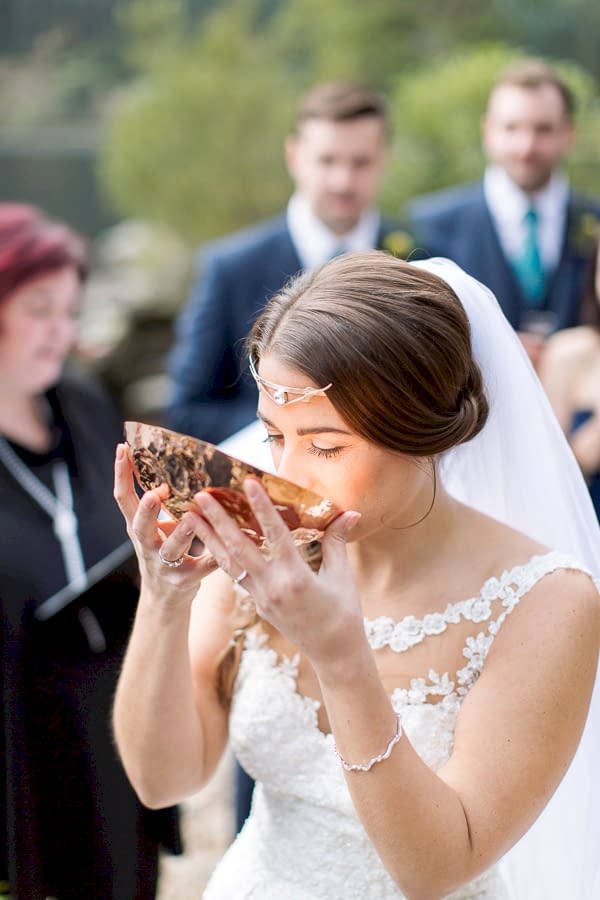 bride drinking from quechee wedding ceremony