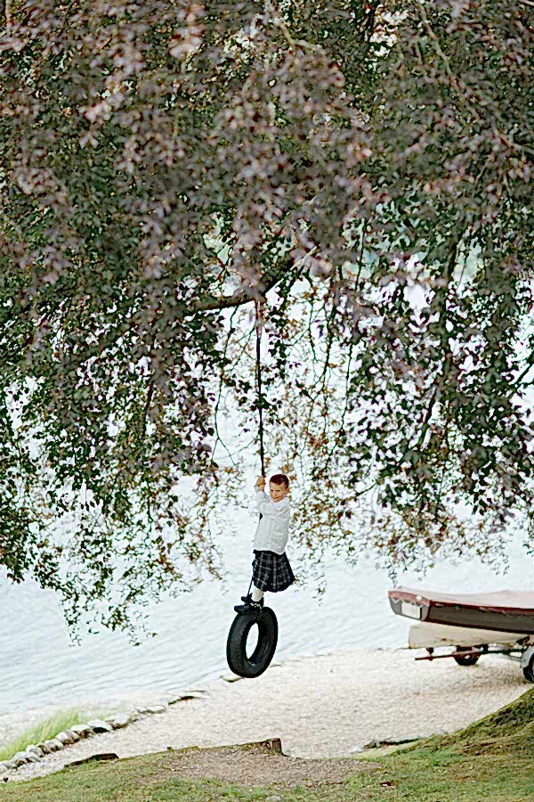 boy on a tire swing