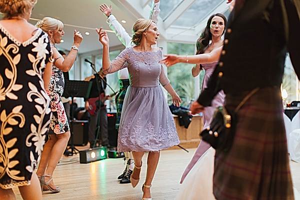 guests and bridesmates dancing
