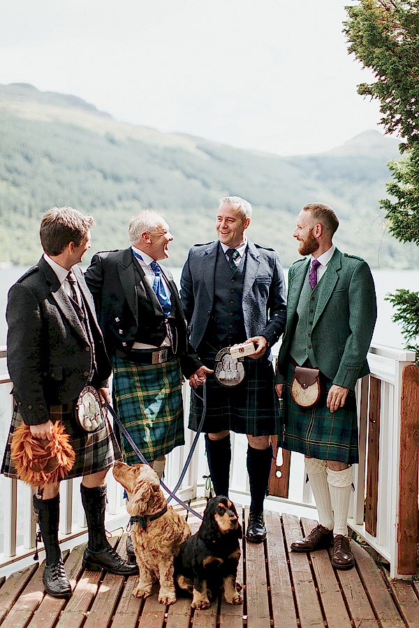 groom with groomsmen and dogs