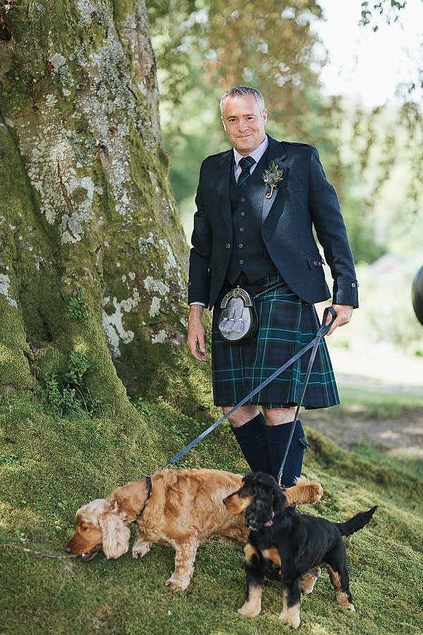 groom with dogs before wedding ceremony in a dog firnedly scottish venue
