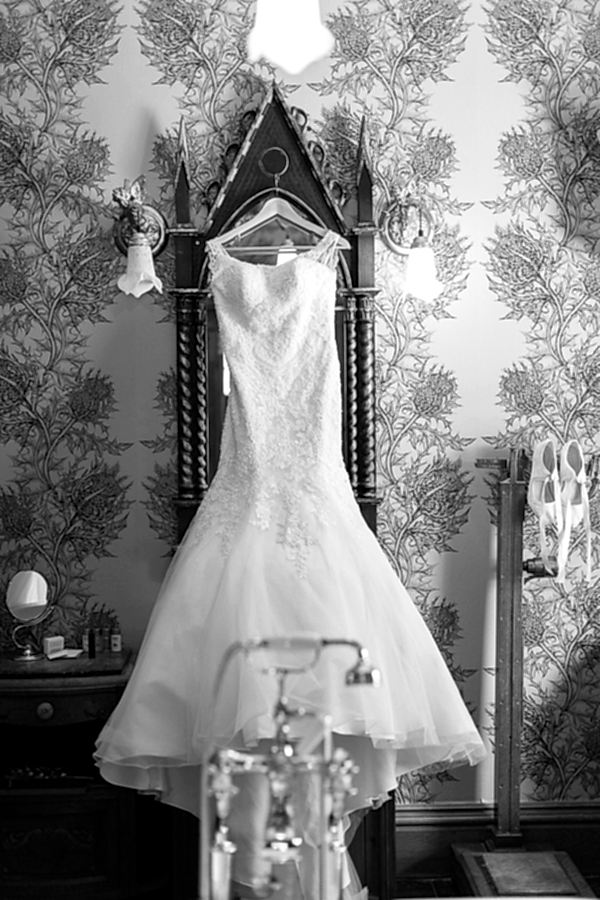 wedding dress hanging on a vintage victorian mirror at the lodge on loch goil
