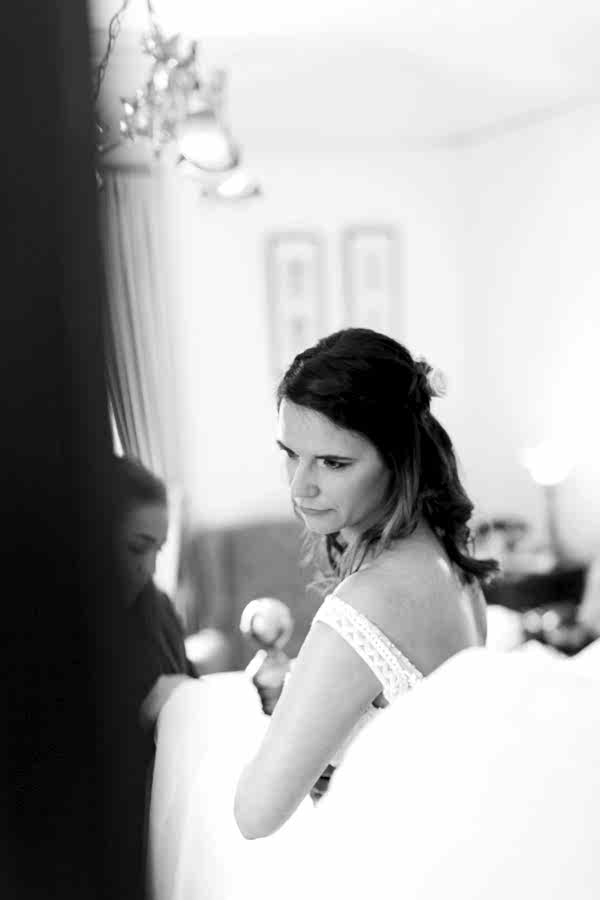 bride puting her wedding dress