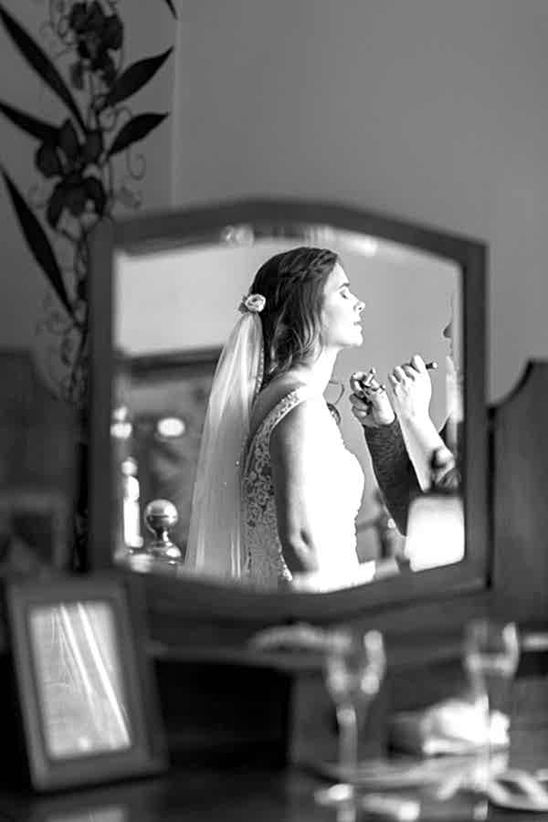 bride having her makeup done final touches