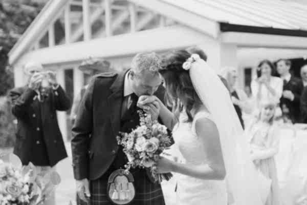 groom kissing bride in her hand before ceremony