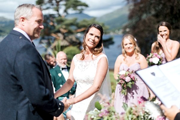 bride and groom smiling during ceremony
