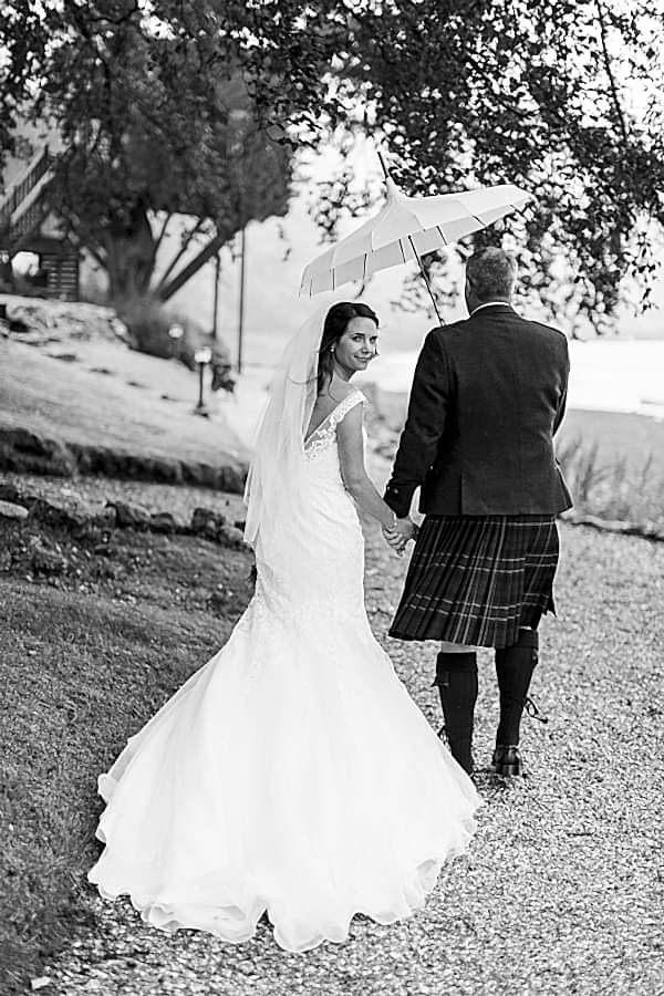 beck of the dress while bride and groom walking away