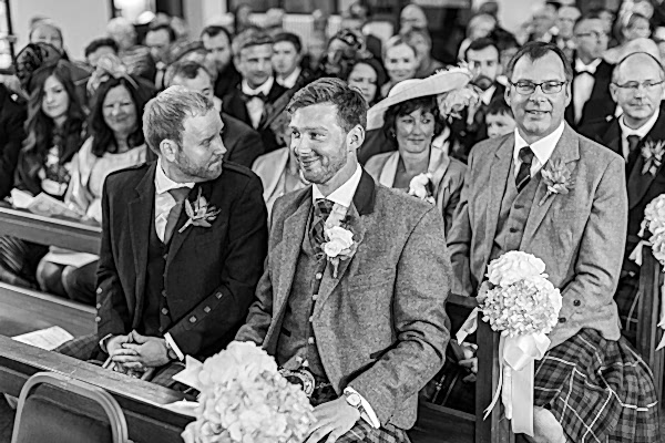 happy groom waiting at the church in bearsden 