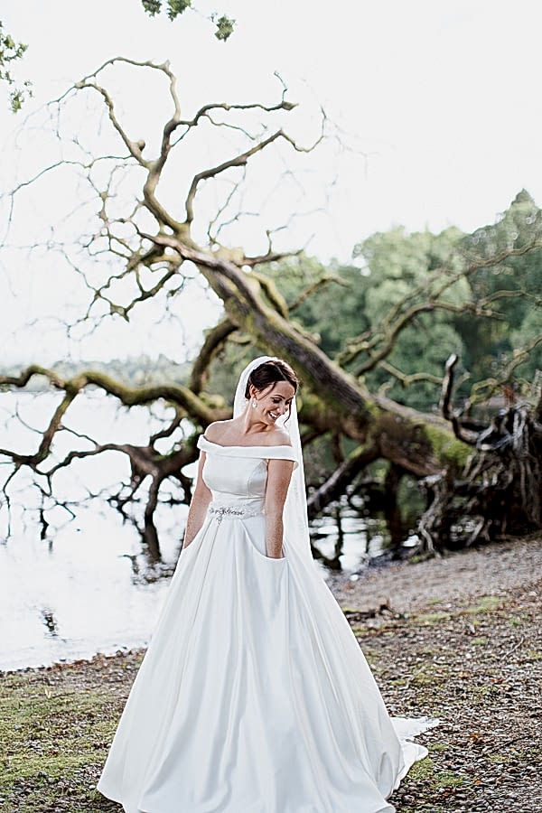 bride with her hands in pockets in dress wedding near glasgow