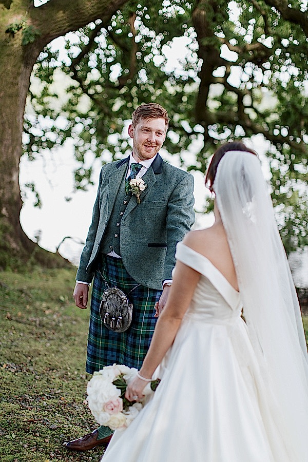 groom looking at bride with evening light