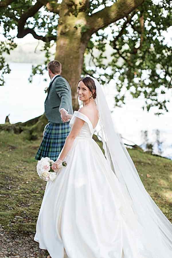 wedding photographer cameron house groom pulling bride