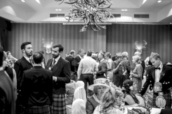 guests chatting at wedding in cameron house hotel