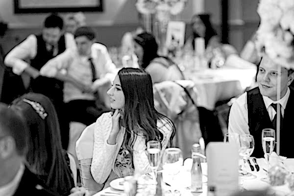 guests looking at groom during wedding speech