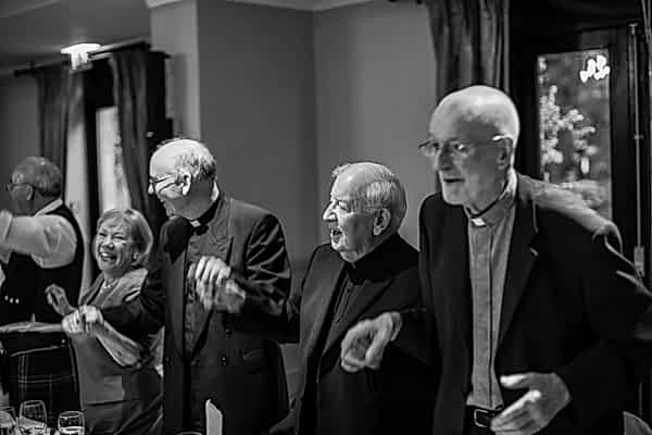 ministers standing and dancing during wedding