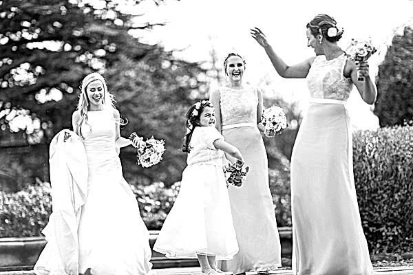 happy bridal party getting photrographed outside of mar hall