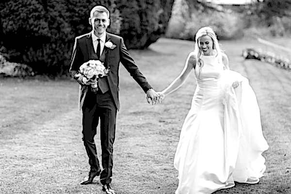married couple walking in the gardens of mar hall 