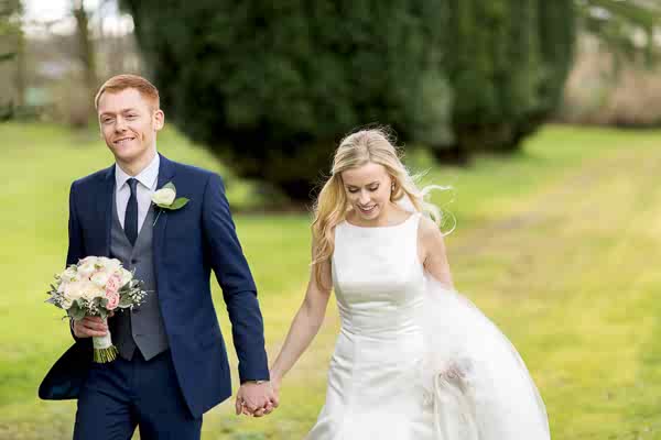 groom holding birdes hand at mar hall scotland