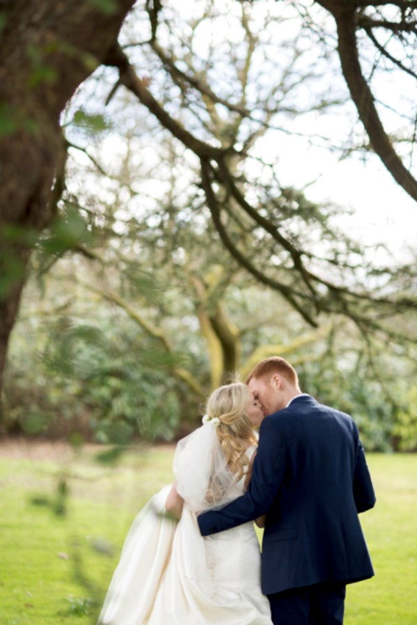 kissing under the tree at wedding venue mar hall scotland