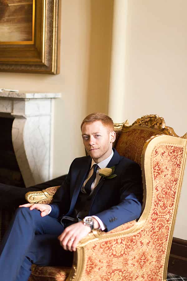 groom sitting in the armchair mar hall scotland 