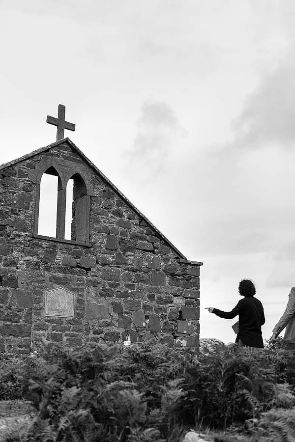 groom preparing for ceremony on a beach, church ruin in scotland