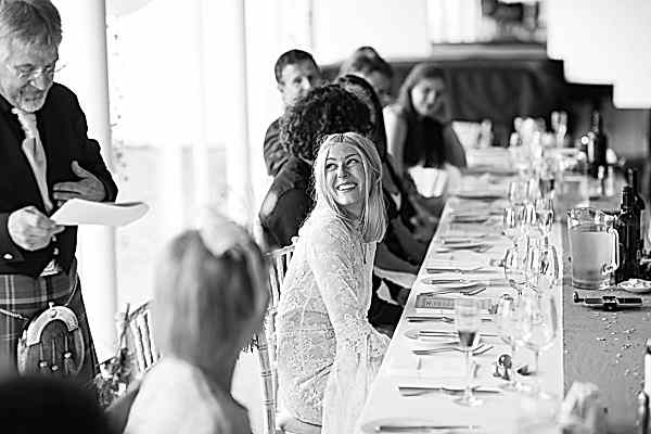 bride smiling at her dad during speeches