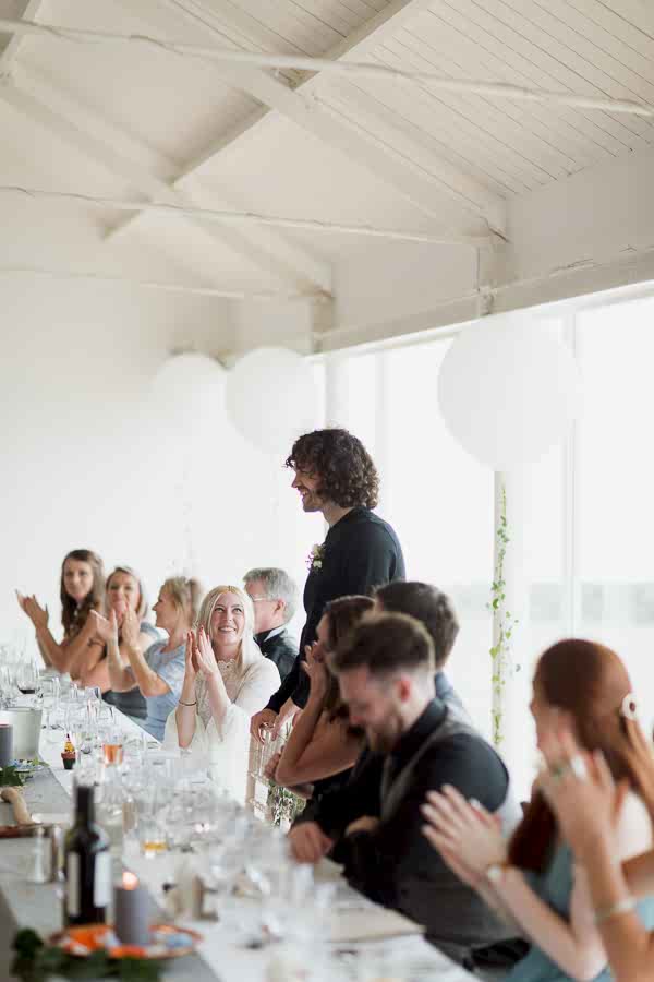 groom during his wedding speech with guests claping