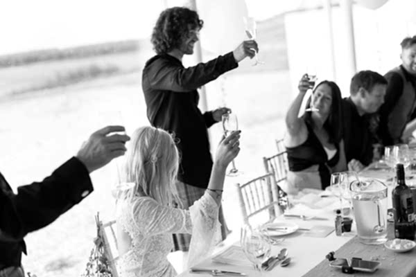 groom raising toast during wedding speeches at crear