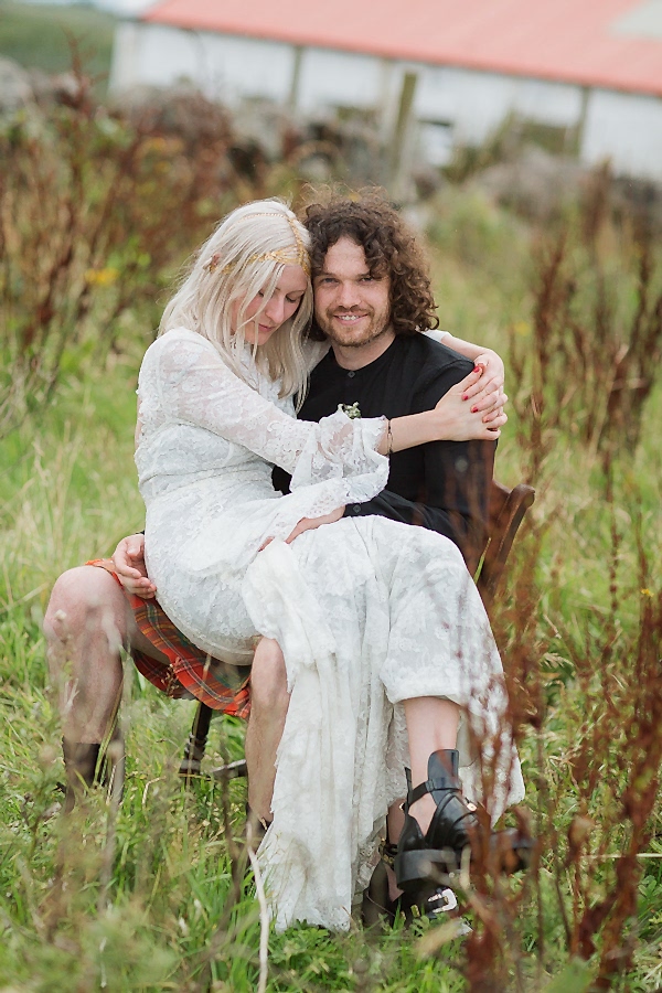 bride and groom sitting in a garden