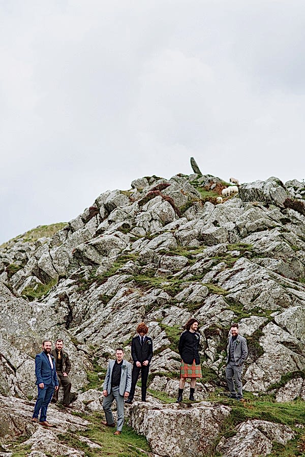 groom and his men on a rocky beach