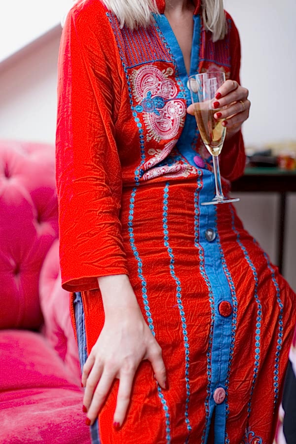 bride in oriental robe holding champaign glass at crear