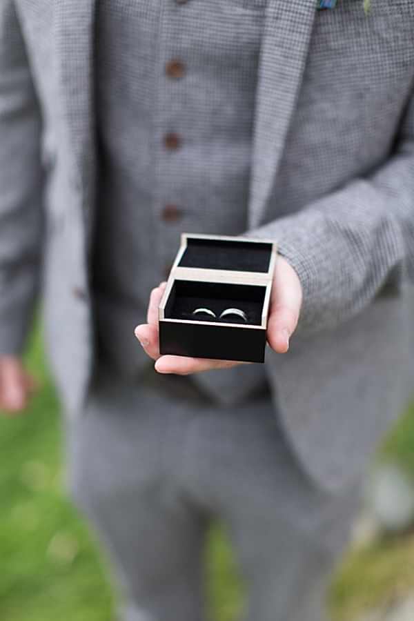 best man holding wedding rings