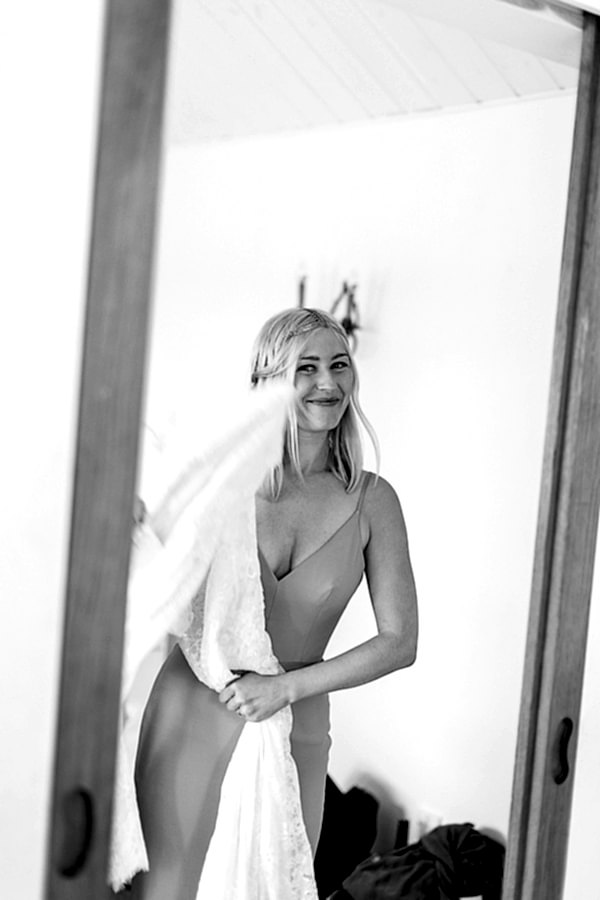 bride smiling holding her wedding dress