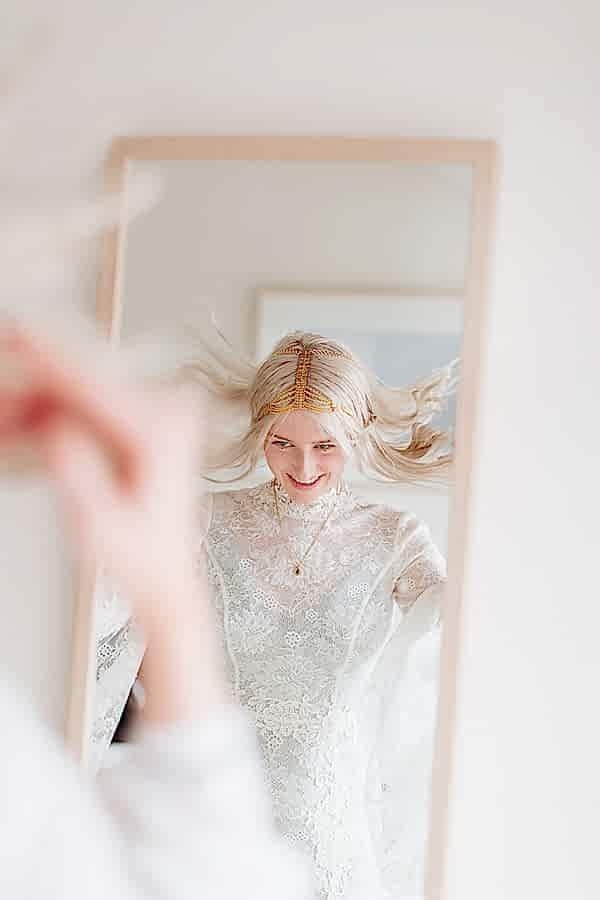 bride fixing her hair during preparations