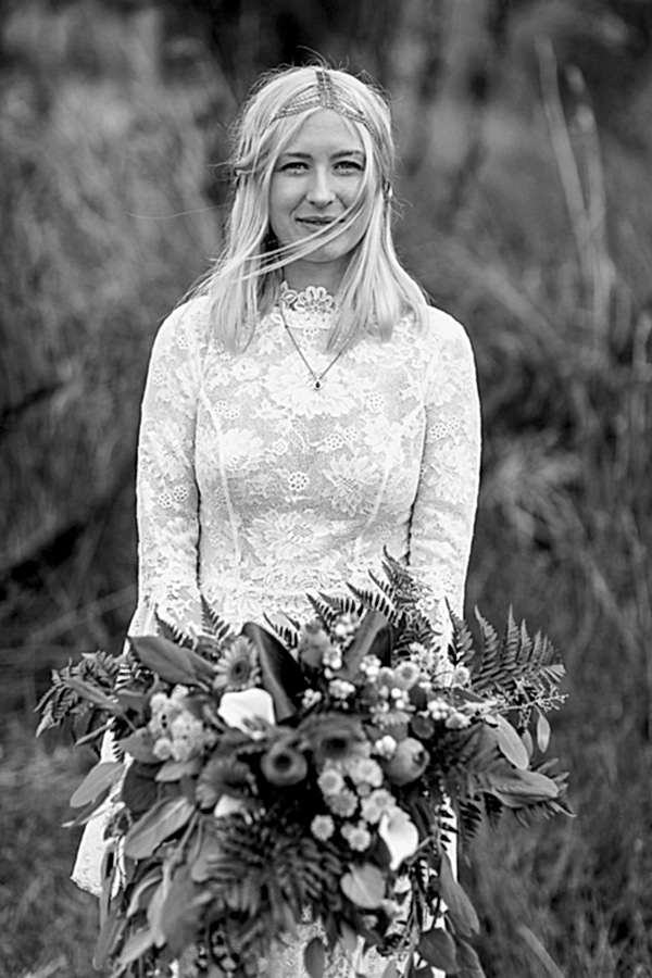 portrait of bride holding flowers and looking at the camera